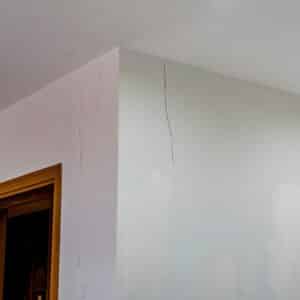 White painted house with cracked wall near ceiling need to be fixed