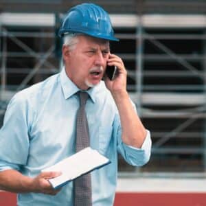 Angry senior engineer shouting at the phone